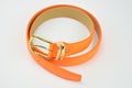 There is an orange artificial leather belt