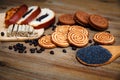 There are Pieces of Roll with poppyseed,Cookies,Halavah,Chocolate Peas,Tasty Sweet Food on the Wooden Background