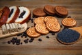 There are Pieces of Roll with poppyseed,Cookies,Halavah,Chocolate Peas,Tasty Sweet Food on the Wooden Background
