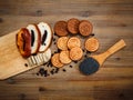 There are Pieces of Roll with poppyseed,Cookies,Halavah,Chocolate Peas,Tasty Sweet Food on the Wooden Background,Top View Royalty Free Stock Photo