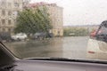 There is rainy weather outside the car window, raindrops on the glass. Bad weather and poor visibility Royalty Free Stock Photo