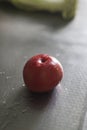 There is a red washed fresh tomato on the table