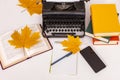 Workplace of modern writer with old typewriter, books, notebook and pen, telephone. View from above. Autumn mood. Royalty Free Stock Photo