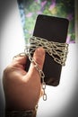 There`s a phone in my hand. They are in a chain. There is vignetting Royalty Free Stock Photo