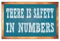 THERE IS SAFETY IN NUMBERS words on blue wooden frame school blackboard