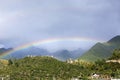 There are several cabins in the beautiful rainbow mountain in the sky after the rain