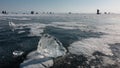 There are shiny shards of ice on the frozen lake.