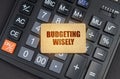 There is a sign on the calculator that says - Budgeting wisely