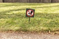 There is a sign on the lawn with a sign forbidding walking on the grass Royalty Free Stock Photo