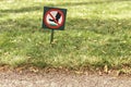 There is a sign on the lawn with a sign forbidding walking on the grass Royalty Free Stock Photo