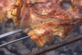 A beautifully toasted piece of pork smokes on the grill