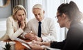 There is some interesting material here. Shot of a focused mature couple negotiating with a architect over house plans