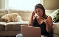 There are some things that not even credit can fund. a young woman looking stressed while using a laptop and credit card Royalty Free Stock Photo