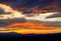 Wind turbine at sunset with beautiful clouds Royalty Free Stock Photo