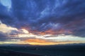 Wind turbine at sunset with beautiful clouds Royalty Free Stock Photo