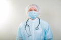 Portrait of a doctor man in a medical mask. There is a stethoscope on the doctor`s neck. During a pandemic, remedies are essentia