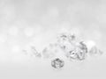 There are still expensive cut diamonds in front of the white background reflecting on the ground, lots of copying Royalty Free Stock Photo