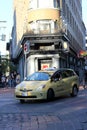 there is a taxi cab stopped on a busy city street Royalty Free Stock Photo