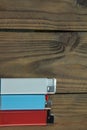 There are three lighters on a wooden surface - white, blue, red. Space for text, blank mockup on the lighter. Lighters Royalty Free Stock Photo