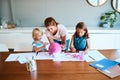 Always there to get down and dirty with them. a young mother helping her two small children with their art project at Royalty Free Stock Photo