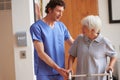 There to provide encouragement along the way. a male doctor assisting his senior patient whos using a walker for support Royalty Free Stock Photo