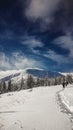 there are tracks left in the snow by a man walking up the mountain