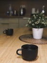 there are two black cups with tea on the table Royalty Free Stock Photo