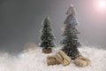 There are two Christmas trees in the snow. gifts in craft packaging under the tree Royalty Free Stock Photo