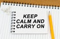There are two notebooks and a pencil on the table. On the top notepad, the inscription - Keep Calm And Carry On Royalty Free Stock Photo