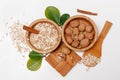 There are with Walnuts and Rolled Oats in the Wooden Plates with Sticks of Sinnamon,Wooden Support,Spoon,Green LeavesHealthy Royalty Free Stock Photo