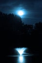 Moody Blue Full Moon Over Pond With Fountain Royalty Free Stock Photo