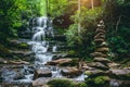 There is a waterfall behind and a pile of rocks in the foreground Royalty Free Stock Photo