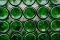 There were layers of green bottles bottles piled up and there were many