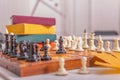 There is old wooden chessboard on table. Game began, players made their moves. Royalty Free Stock Photo