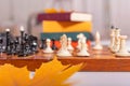 There is old wooden chessboard on table. Game began, players made their moves. Royalty Free Stock Photo