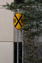 there is a yellow road sign sitting outside of the building