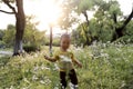 Happy joyful Asia Chinese little boy toddler child enjoy Spring have fun outside embrace nature outdoor carefree childhood flower Royalty Free Stock Photo