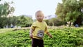 Happy joyful Asia Chinese little boy toddler child enjoy Spring have fun outside embrace nature outdoor carefree childhood meadow Royalty Free Stock Photo