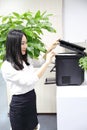 Asia Chinese office lady woman girl printing material use printer at work smile wear business occupation suit workplace Royalty Free Stock Photo