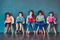 Theres a lot to learn. Studio shot of a group of kids sitting on chairs and reading books against a blue background. Royalty Free Stock Photo