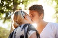 Theres magic in that first kiss. A young couple in love kissing against the bright sun. Royalty Free Stock Photo