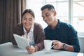 Theres so much trending online today. a young couple using a digital tablet together at home.