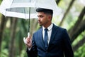 Theres new opportunity around every corner. a young businessman holding an umbrella on a rainy day in the city. Royalty Free Stock Photo