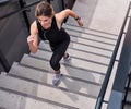 Theres no taking any shortcuts on the journey to fitness. High angle shot of a sporty young woman running up a staircase