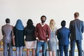 Theres no turning back now. Portrait of a cheerful young businessman standing in line while waiting for an interview and Royalty Free Stock Photo