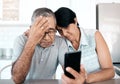 Theres nothing we cant face together. a senior couple looking unhappy while using a phone at home. Royalty Free Stock Photo