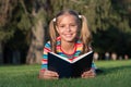 Theres nothing like reading. Happy reader. Cute reader read book on green grass. Small reader enjoy reading. Little Royalty Free Stock Photo