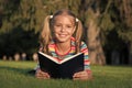 Theres nothing like reading. Happy reader. Cute reader read book on green grass. Small reader enjoy reading. Little Royalty Free Stock Photo