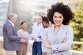 Theres nothing my team cant do. an attractive young businesswoman standing outside with her arms folded while her Royalty Free Stock Photo