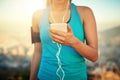 Theres a playlist for that. a young woman listening to music while out for a run.